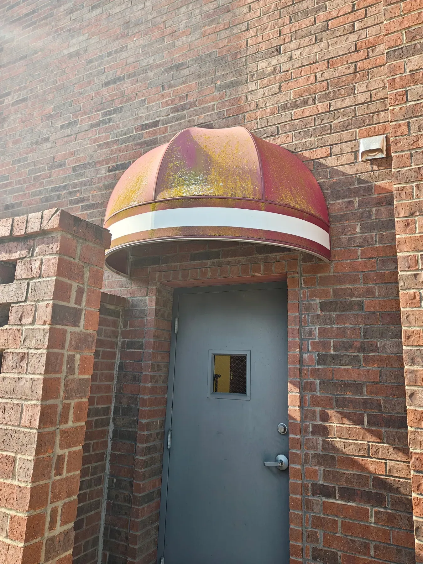 Bank of DeSoto red entrance awning before cleaning