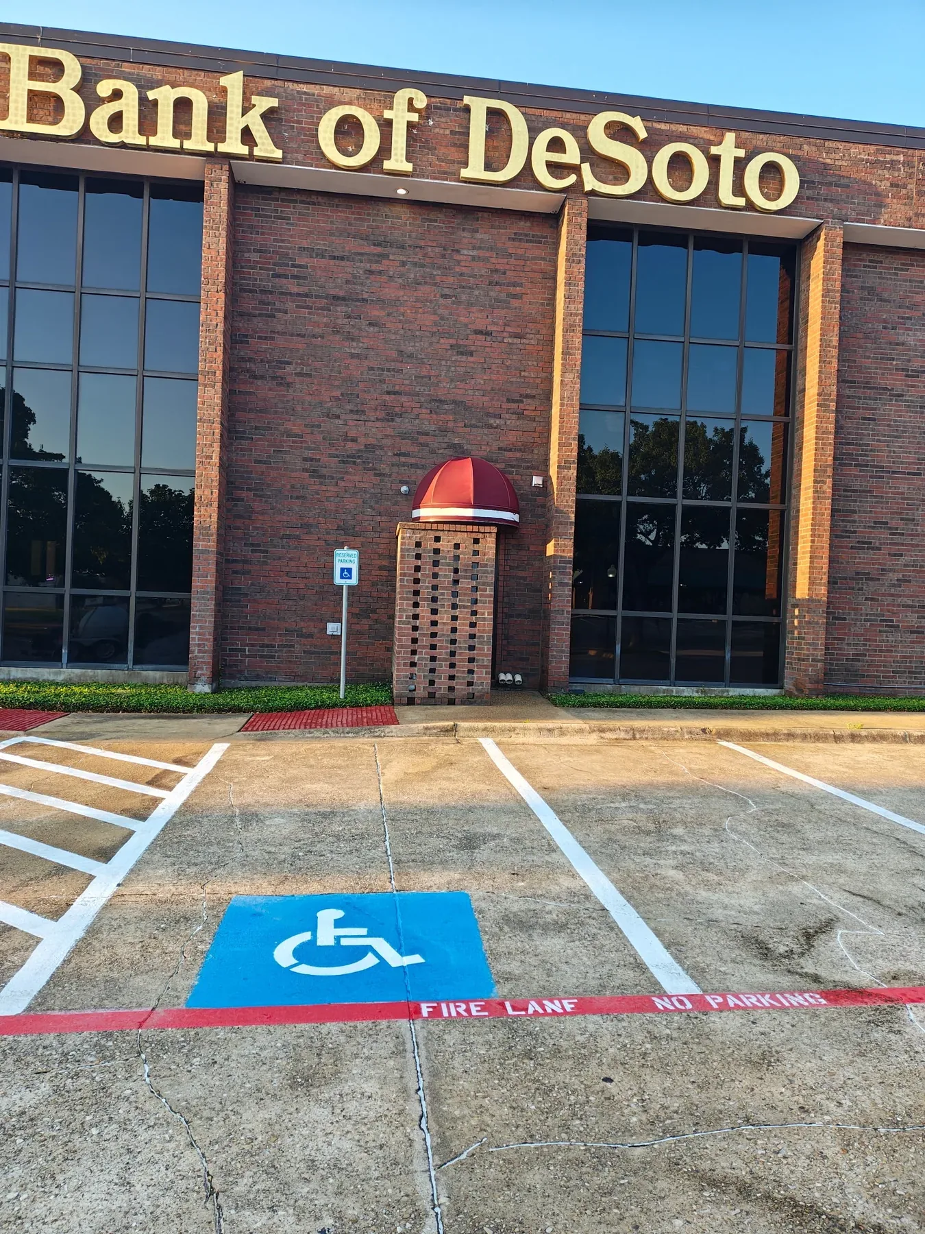 Bank of DeSoto exterior after pressure-washing service, showing the cleaned entrance awning