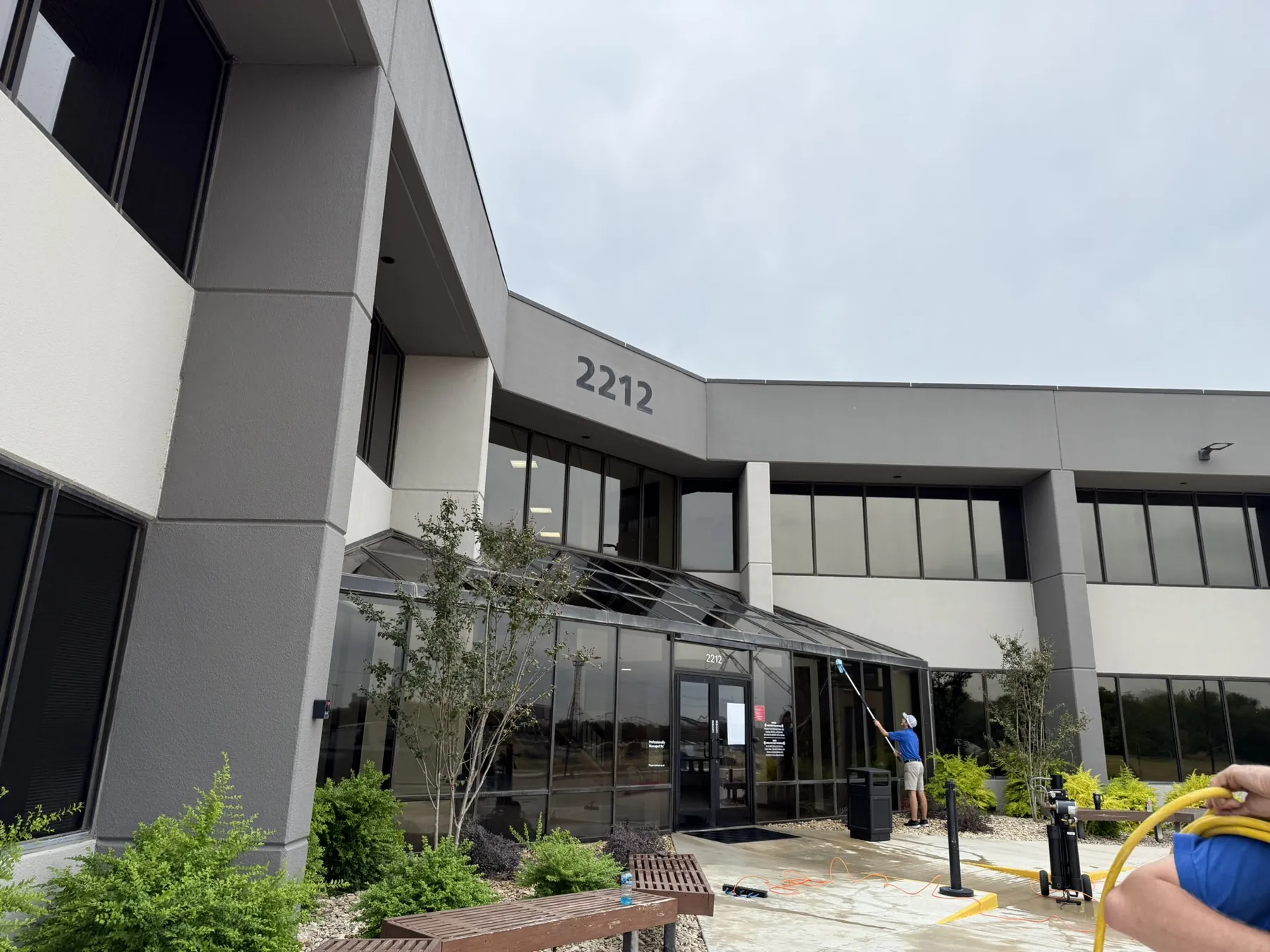 Technician using Pure Water Cleaning on commercial windows