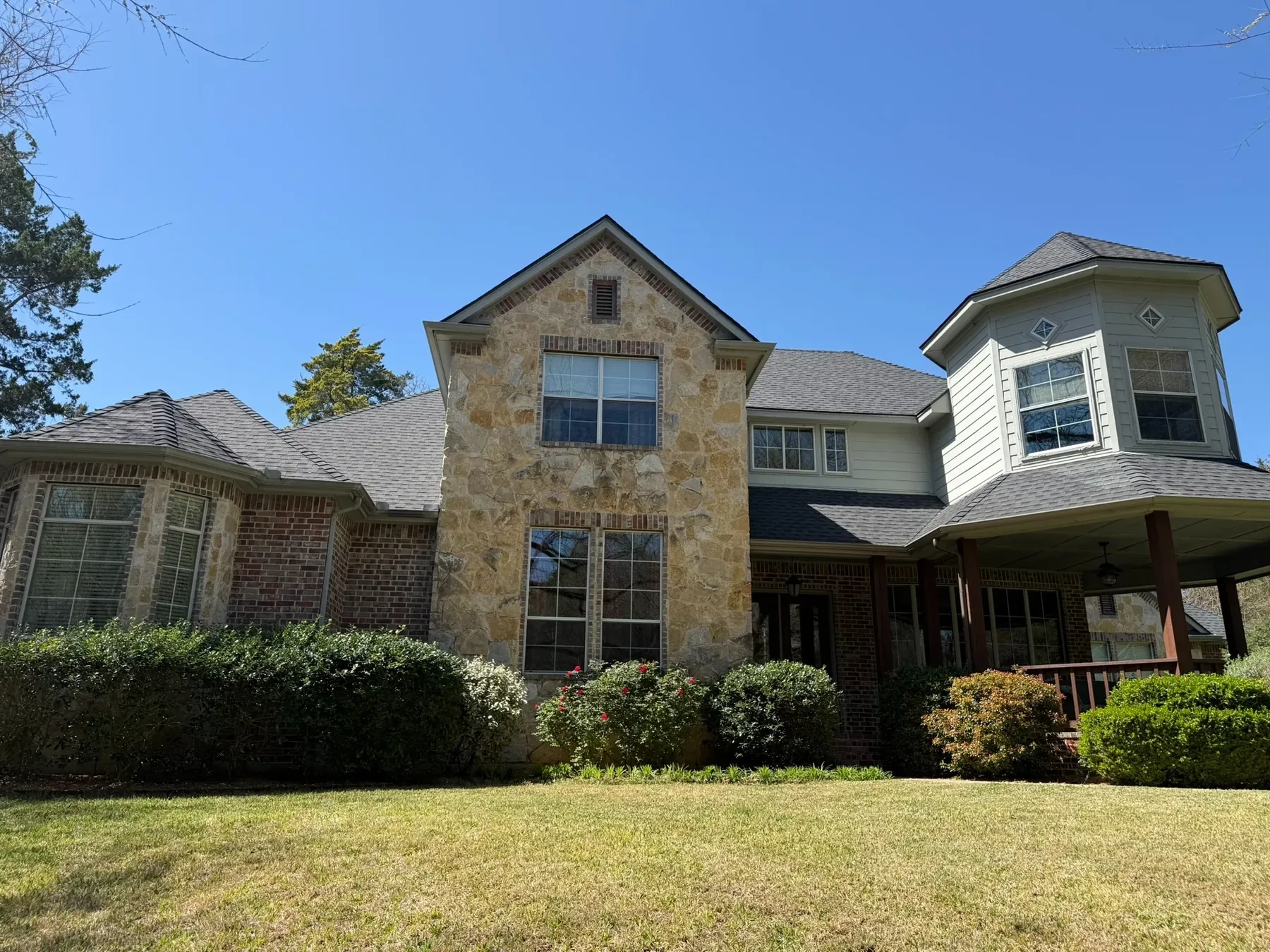 Stone and brick home with upper and lower windows