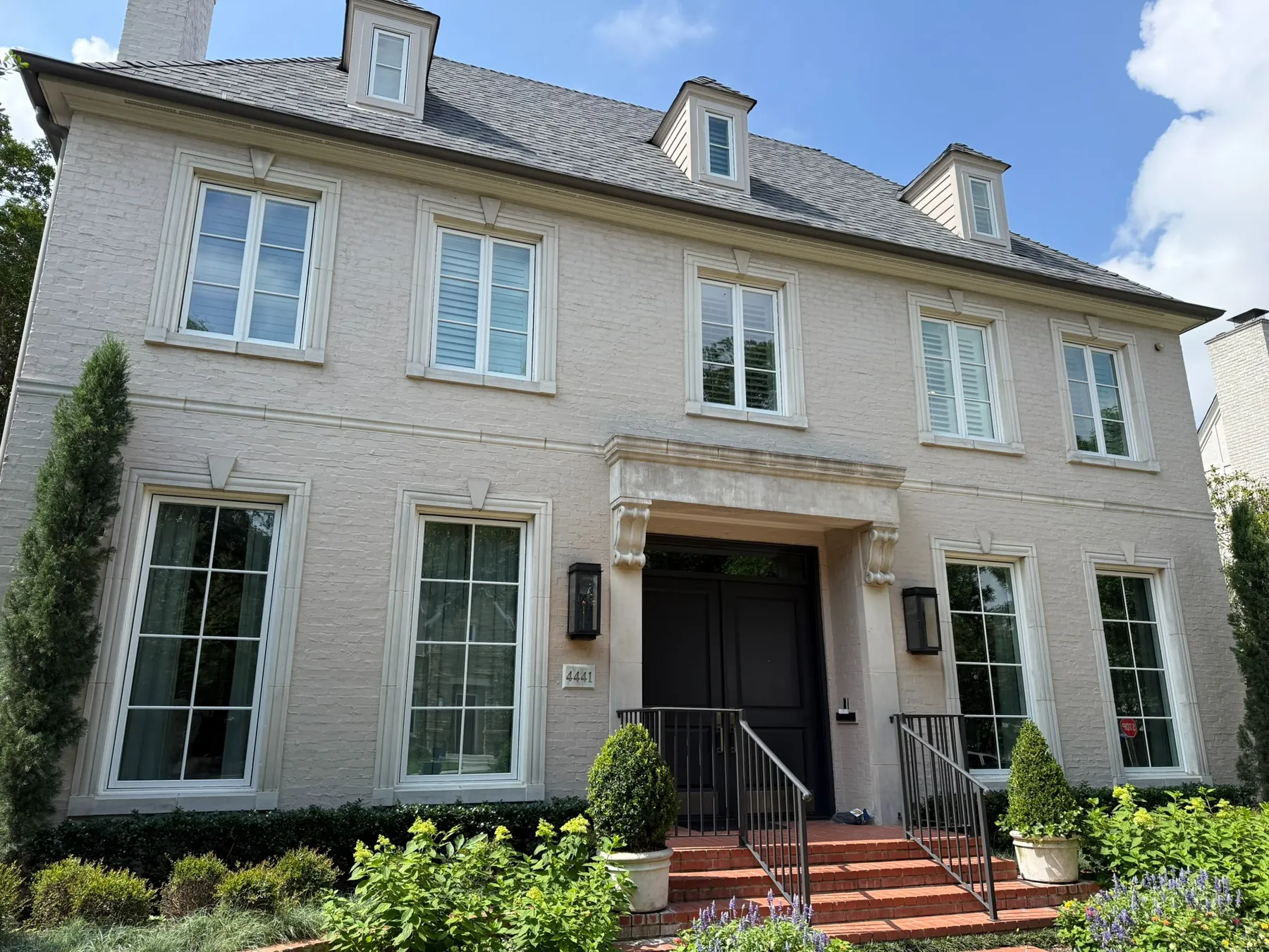 White brick home with multiple windows